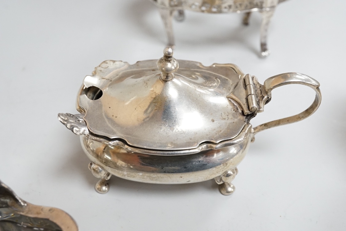 A pair of George III pierced silver shaped oval salts by Hester Bateman, London, 1783 (a.f.), with clear glass liners, together with one other George III silver oval salt, London, 1783 and two later silver mustard pots.